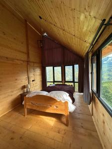 a bedroom with two beds in a log cabin at GR Qobu merisi in Inasharidzeebi