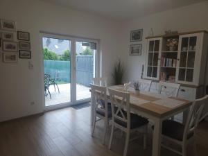 a dining room with a table and chairs and a sliding glass door at Diamentowa 7 Rent Home Konarzewo Poznań in Poznań