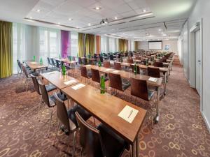 a conference room with wooden tables and chairs at Clarion Congress Hotel Bratislava in Bratislava