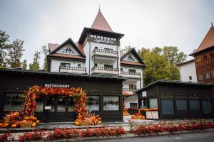 a building with an arch in front of it at Pensiunea Sylvania in Sovata