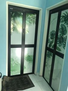 a room with sliding glass doors in a house at DChemara Mizi Homestay Swimming Pool in Sik