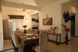 a dining room with a long table and chairs at Hikka Resort in Hikkaduwa