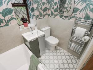 a small bathroom with a toilet and a sink at Court Street Cottage in Saddleworth +23 photos