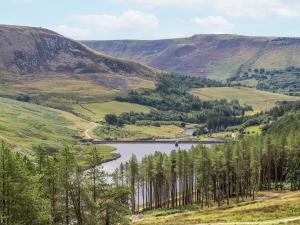 a view of a valley with a lake and trees at Court Street Cottage in Saddleworth
