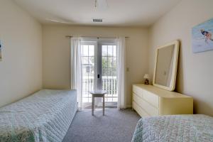a bedroom with two beds and a dresser and a window at Ocean City Family Getaway about Qtr-Mi to Beach! in Ocean City