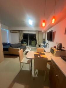 a kitchen and living room with a table and chairs at Studio in Haven in Bangkok