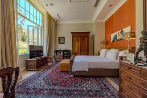 a bedroom with a bed and a large window at 21 Nettleton Boutique Hotel & Luxury Residence in Cape Town