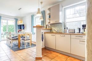 a kitchen with a table and a dining room at Haus Arielle in Prerow +27 photos