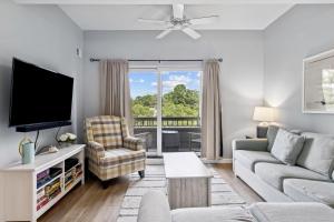 a living room with a couch and a tv at 891 Ketch Court in Hilton Head Island