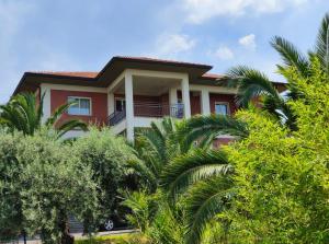 a red house with trees in front of it at La Ginestra Dell' Etna in Adrano