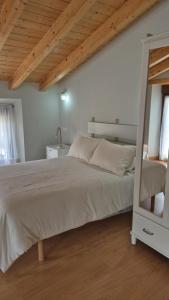 a bedroom with a large bed and a wooden ceiling at La Posada De Faustina in Naveda