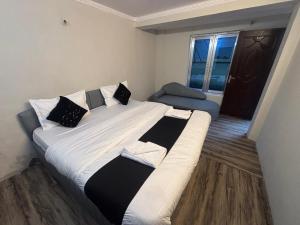 a large bed in a small room with a window at The Mist Nainital Hotel in Nainital
