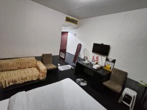 a living room with a bed and a television at Summer home stay 01 in Abu Dhabi