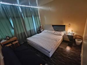 a bedroom with a bed and a desk and a window at Summer home stay 04 in Abu Dhabi