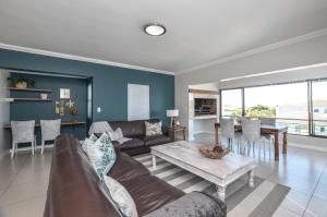 a living room with a couch and a table at Apartment 6 in Yzerfontein