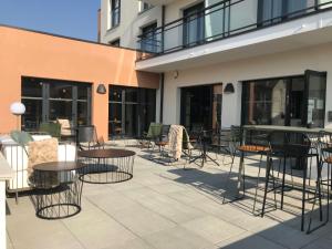 a patio with tables and chairs next to a building at ibis Styles Dreux Centre Gare in Dreux