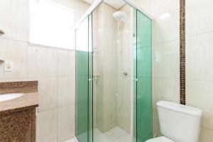 a bathroom with a toilet and a glass shower at Res. Wilian 308 - Apto 2 quartos em Bombas in Bombas +16 photos