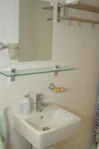 a white bathroom with a sink and a mirror at The Coach House at Stowford House in Babcary +10 photos