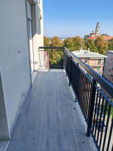 a balcony of a building with a wooden deck at Casa ALFRED FIDENZA in Fidenza
