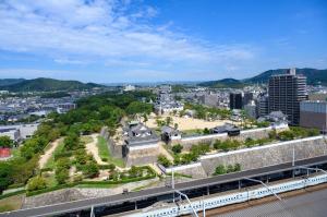 an aerial view of a city with a train at Fukuyama New Castle Hotel in Fukuyama