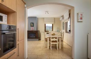 a kitchen with a table and a dining room at Olive Garden Villa Chania in Chania