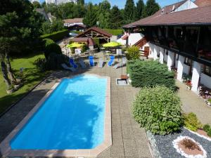 an overhead view of a swimming pool in a yard at La Vieille Ferme in Étupes