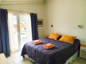 a bedroom with a bed with two towels on it at Departamento Costa Ramayon in San Martín de los Andes