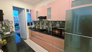 a kitchen with a stainless steel refrigerator and a window at Cherry Blossom Hideaway Elegant 3BHK Cozy Ambience With Pool in Dabolim