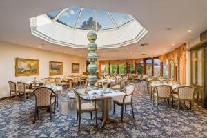 a dining room with tables and chairs and a skylight at Aspire Oldenburg, Trademark Collection by Wyndham in Oldenburg