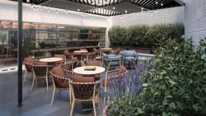 a restaurant with tables and chairs and plants at Hilton Garden Inn Mexico City Polanco in Mexico City