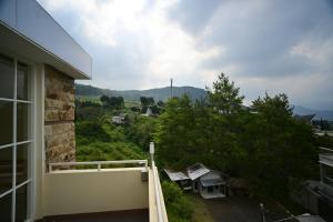 a view of a balcony of a house with trees at Maison Belle in Tlekung