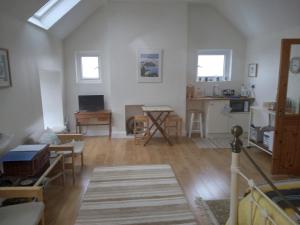 a living room with white walls and wooden floors at Seod Na Mara, Jewel of the Sea, Upstairs Flat, Dun Geagan,Ballinskelligs in Ballinskelligs