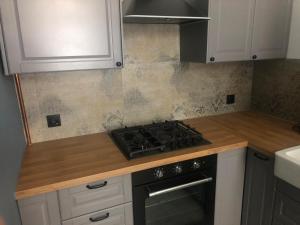 a kitchen with a stove and a counter top at Cosy Sacz in Nowy Sącz +2 photos
