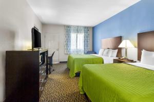 une chambre d'hôtel avec deux lits et une télévision à écran plat dans l'établissement Econo Lodge, à Bryan 44 autres photos