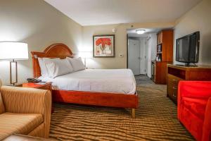 a hotel room with a bed and a flat screen tv at Wyndham Garden Kankakee in Kankakee