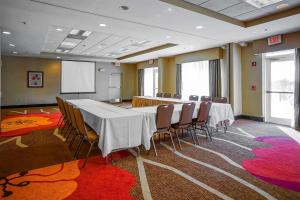 a conference room with a long table and chairs at Wyndham Garden Kankakee in Kankakee