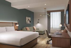 a hotel room with a bed and a desk at La Quinta Inn & Suites by Wyndham Tracy in Tracy
