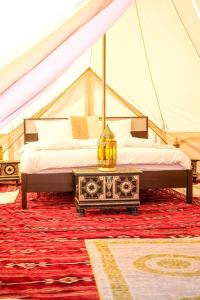 a tent with two beds and a table in a room at Authentic Private Tent in Bidiyah