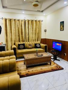 a living room with a couch and a coffee table at 1 bed furnished apartment flat Bahria town Rwp isb in Rawalpindi
