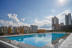 a large swimming pool on the roof of a building at Crowne Plaza Zhongshan Torch High-tech Zone by IHG in Zhongshan
