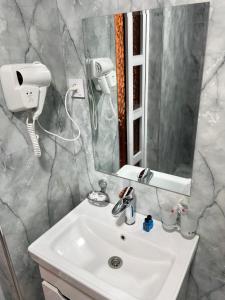 a bathroom with a sink and a mirror at Afruza Hotel in Samarkand