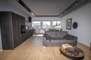 a living room with a couch and a table at LL Properties - TB24 The Boutique Flat in Akureyri
