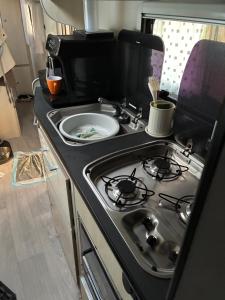 a kitchen with a stove with a plate on it at johan in Middelkerke