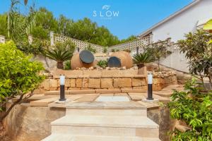 a garden with stone steps and a house at Villa Maravillas by Slow Villas in Playa de Palma