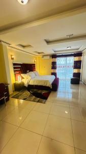 a bedroom with two beds and a window at Applegate Hotel in Yaoundé +14 photos