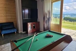 a living room with a pool table and a tv at Widokówka Kluszkowce in Kluszkowce +15 photos