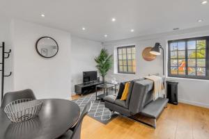 a living room with a table and chairs at Castle Post in Norwich