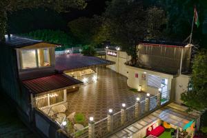 an aerial view of a building at night with lights at Zostel Homes Mussoorie in Mussoorie