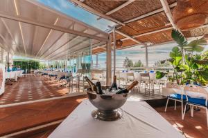 a restaurant with a table with wine bottles on it at Gocce Di Capri Resort in Massa Lubrense