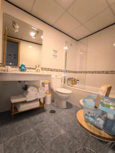 a bathroom with a toilet and a sink and a tub at Casita Piedra Escrita - Private & Exclusive House in Córdoba +39 photos